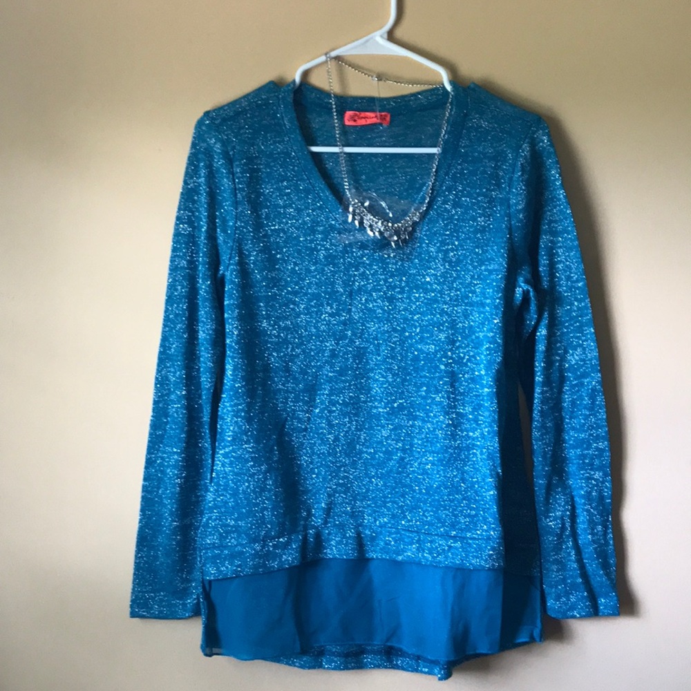 Teal sweater with necklace.